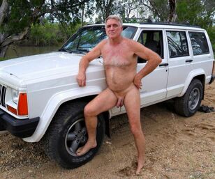Wooly mature masculine posing bare on the nature
