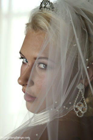 Platinum-blonde bride Katie Summers doffs her wedding..